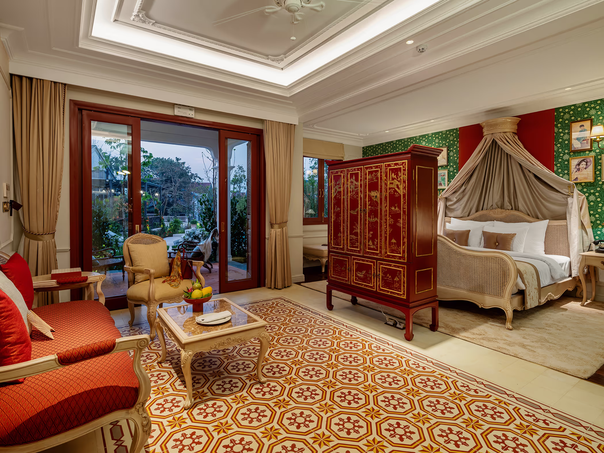 Luxurious French-inspired suite at Ancient Hue Garden Houses showcasing ornate furniture, patterned tiles, and a canopy bed with royal charm.