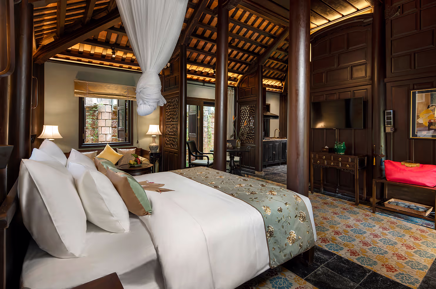 Elegant bedroom at Ancient Hue Garden Houses featuring traditional wooden beams, canopy bed, vintage decor, and handcrafted details inspired by Hue heritage.