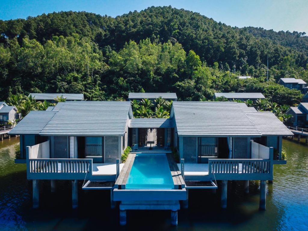 Luxury over-water villas with private pool and sun deck at Vedana Lagoon Resort Vietnam, overlooking tranquil lagoon views.