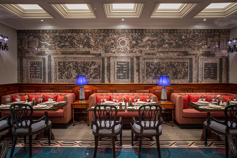 Fine dining restaurant at silk path grand hue hotel featuring traditional Hue decor and luxury seating.