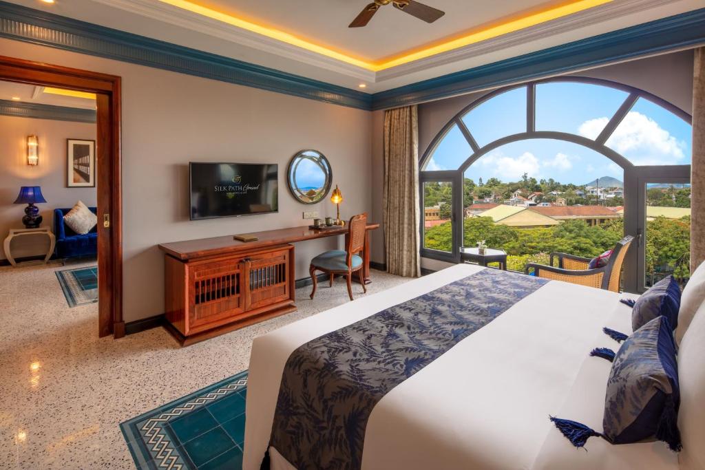 Spacious suite room at silk path grand hue hotel offering panoramic view of Hue city.