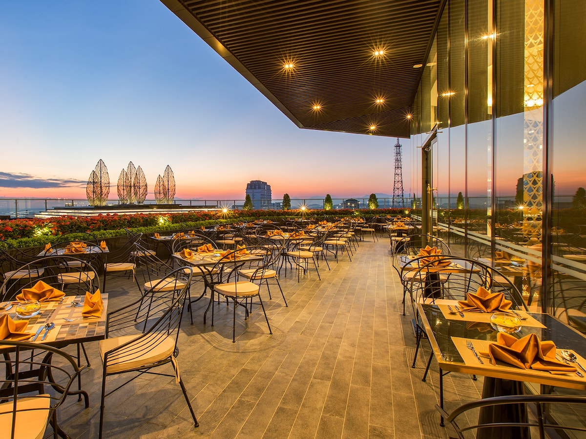 Rooftop terrace restaurant at Melia Vinpearl Hue offering open-air dining and sunset views across the poetic Perfume River.