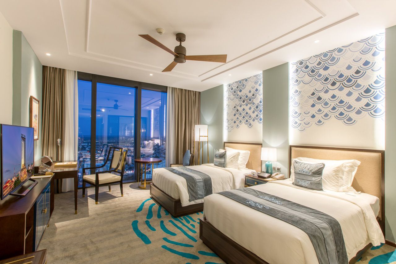Elegant twin room at Melia Vinpearl Hue with panoramic city views, contemporary Vietnamese décor, and modern luxury amenities.