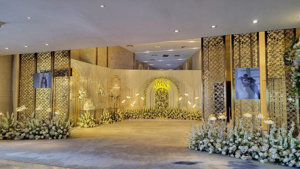 Elegant wedding venue at Melia Vinpearl Hue featuring golden floral décor, luxurious lighting, and a romantic atmosphere for special celebrations. 