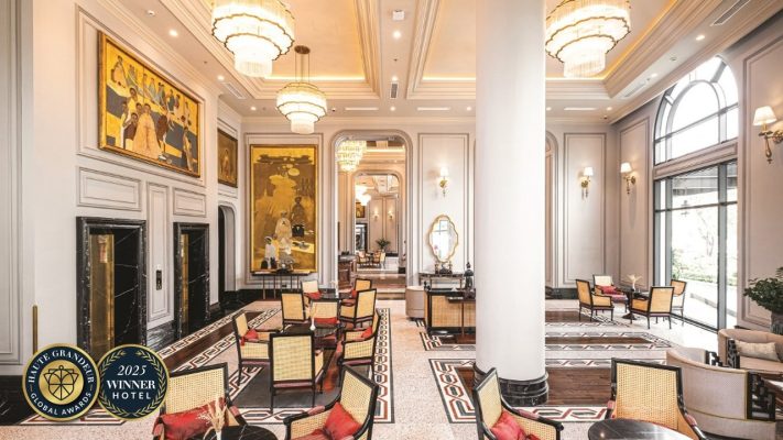 Elegant hotel lobby interior of silk path grand hue hotel with chandeliers and artistic wall decor.