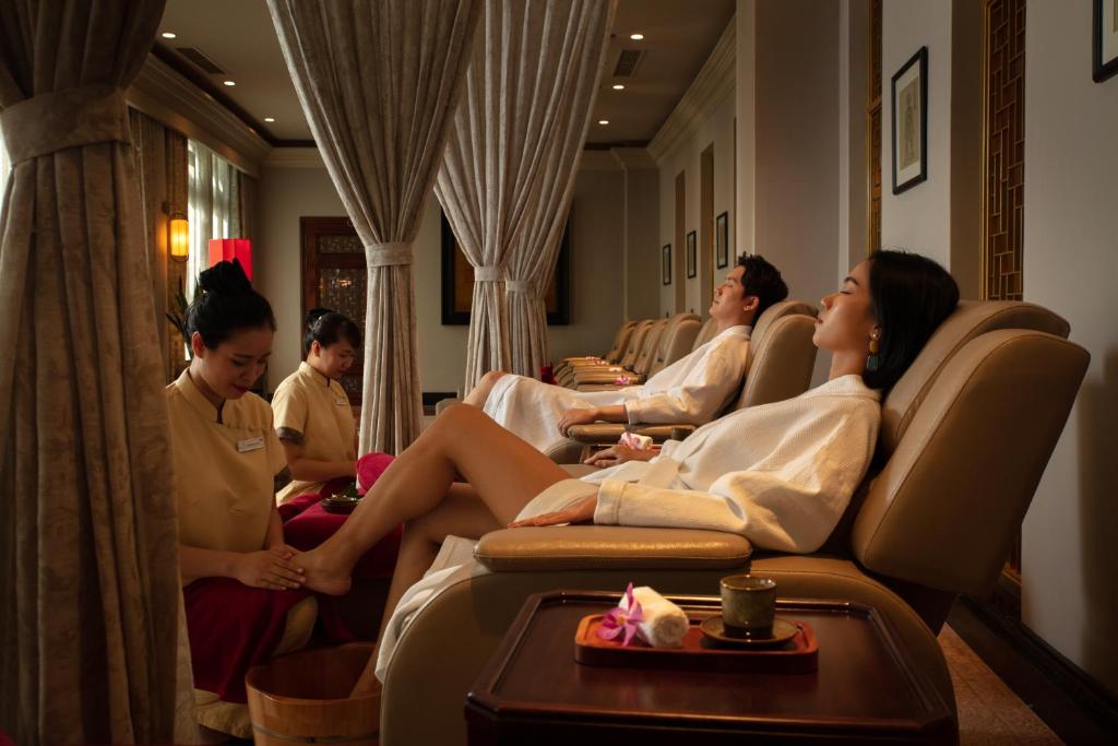 Couple enjoying relaxing foot massage at silk path grand hue hotel luxury spa in Hue Vietnam.