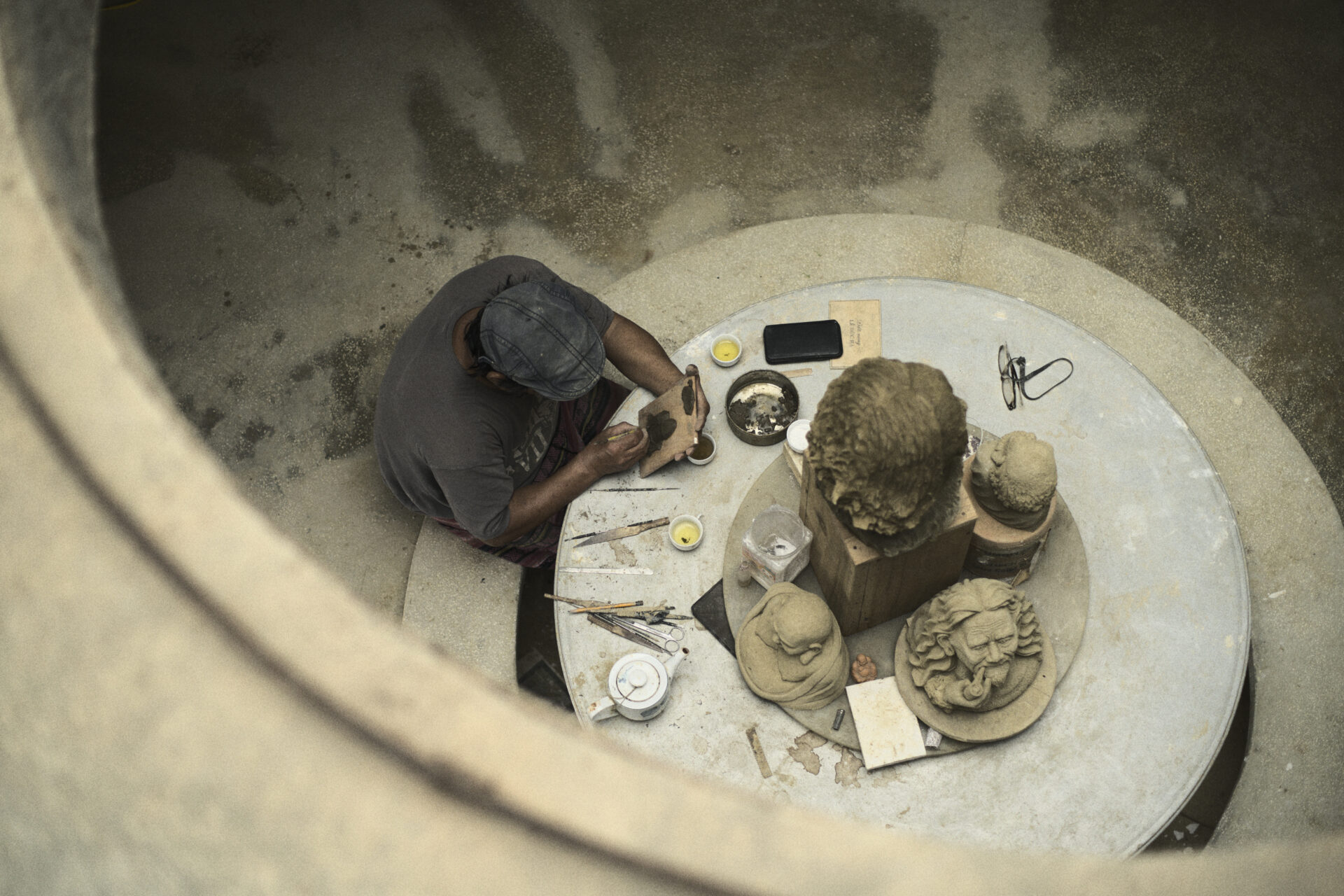 Local artisan creating clay sculptures during cultural workshop at Namia River Retreat, showcasing Vietnamese craftsmanship and tradition.