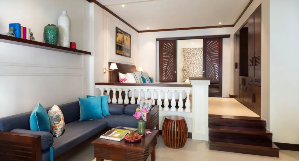 Split-level suite with modern Vietnamese décor and cozy seating at Anantara Hoi An Resort near Hoi An.