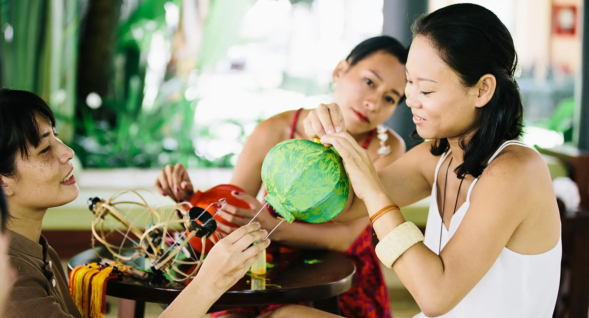 Lantern-making workshop where guests craft colorful paper lanterns at Anantara Hoi An Resort cultural activity.