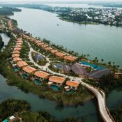Aerial view of Namia River Retreat in Hoi An, Vietnam, showcasing private pool villas surrounded by lush greenery and rivers.