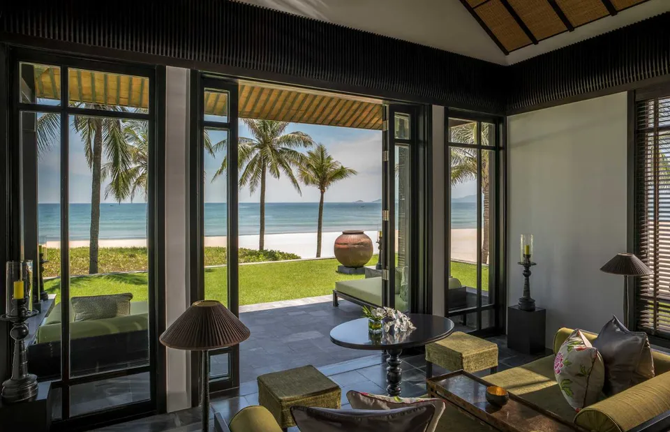 Oceanfront villa living room overlooking Ha My Beach at Four Seasons Resort The Nam Hai, Vietnam.