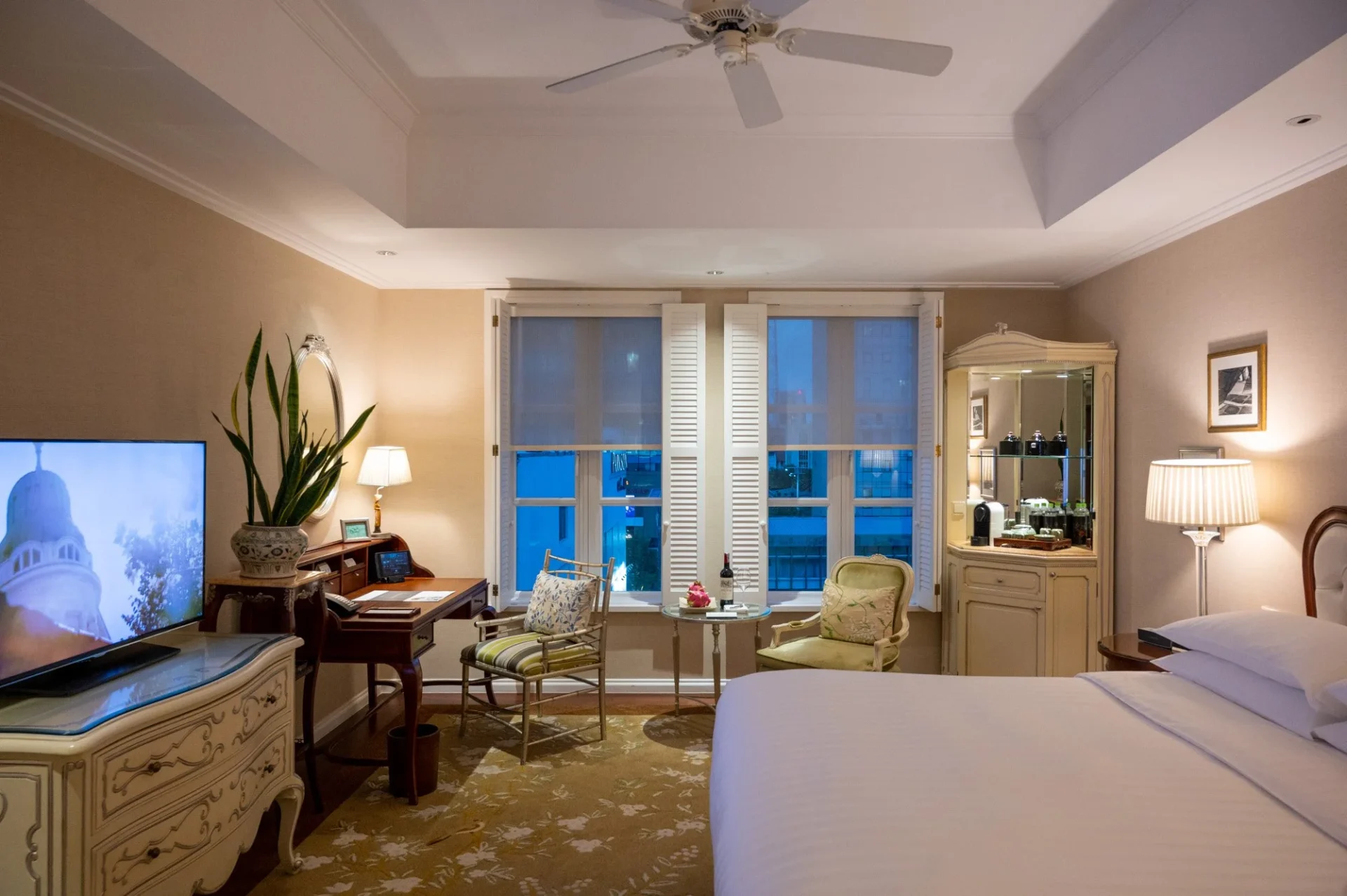 Elegant guest room at Park Hyatt Saigon with city view, classic decor, and warm lighting