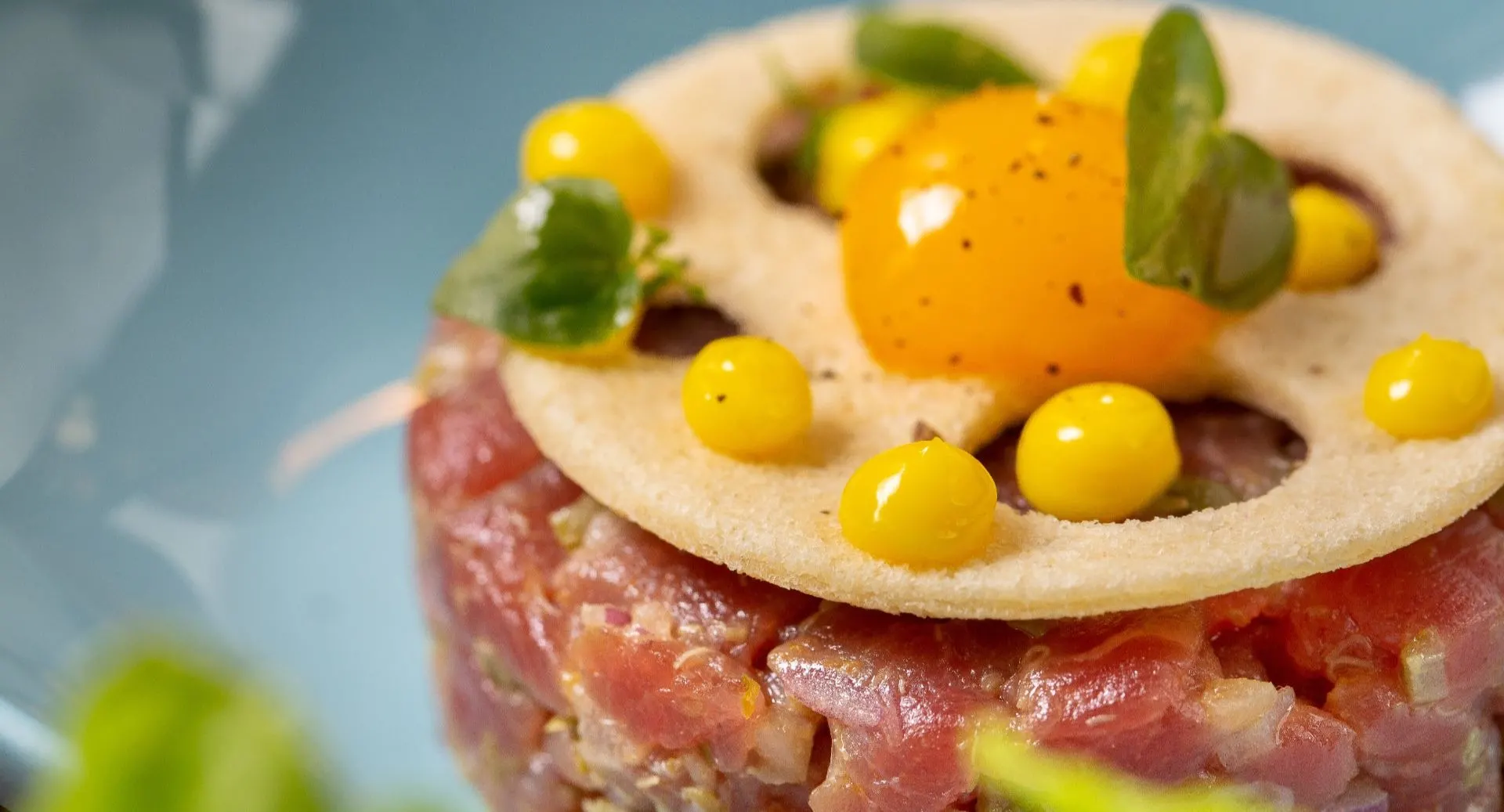 Gourmet tuna tartare with quail egg and vibrant plating at Art Space, Anantara Hoi An Resort restaurant.