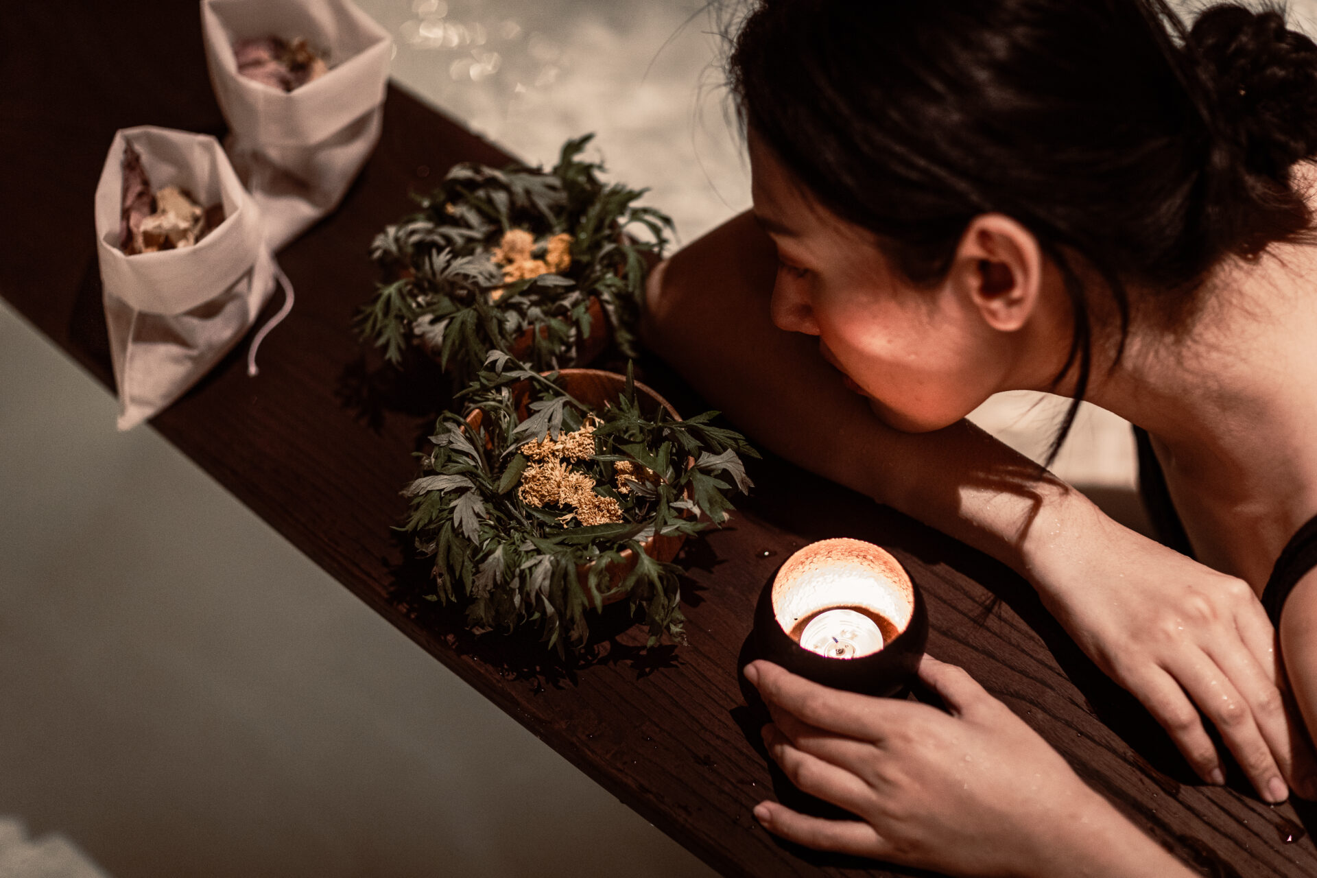 Spa ritual at Namia River Retreat featuring herbal therapy, candlelight, and relaxation inspired by traditional Vietnamese wellness.