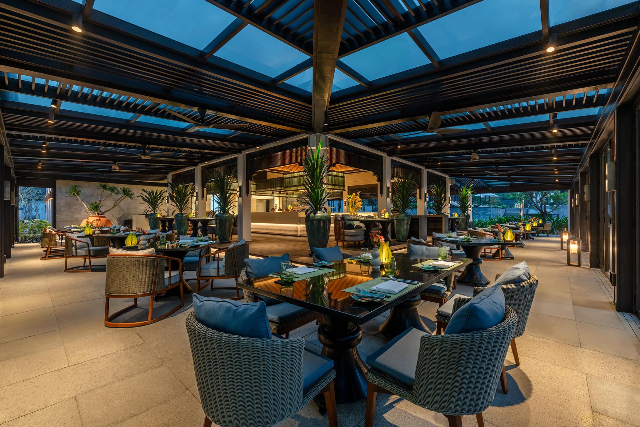 Elegant open-air dining restaurant at Four Seasons Resort The Nam Hai, overlooking tropical gardens.