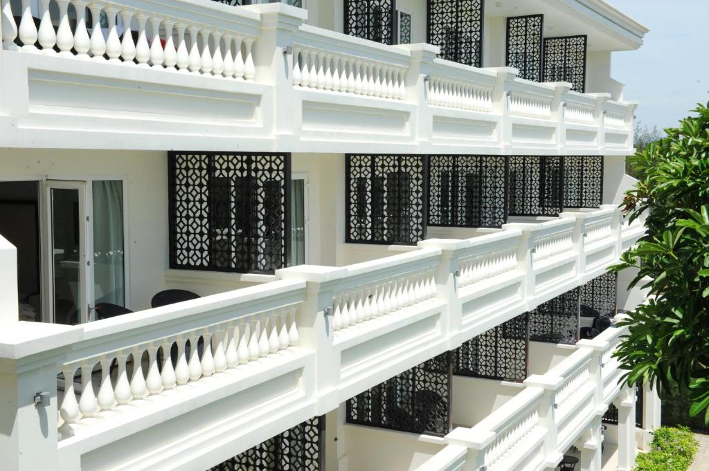 White balconies and decorative lattice details showing colonial-style architecture at Boutique Hoi An Resort.
