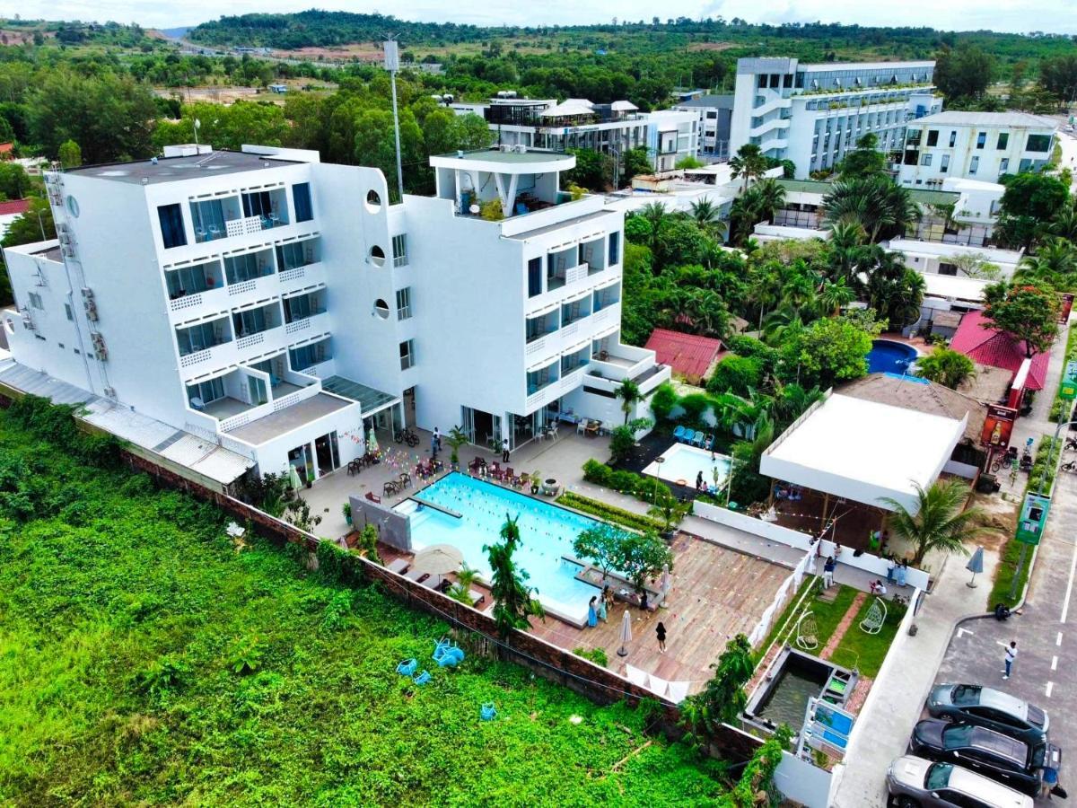 Exterior view of Naia Resort Sihanoukville featuring modern white architecture and landscaped beachfront surroundings