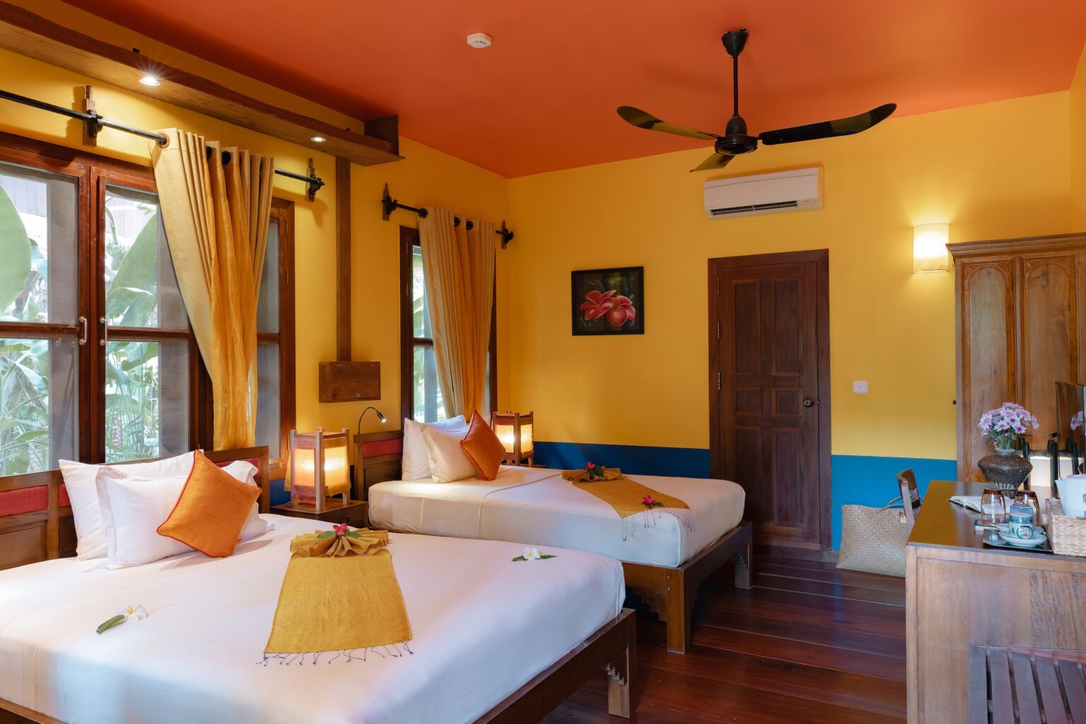 The Frangipane Room at Maisons Wat Kor is ideal for families or groups of friends, featuring a king-size bed directly connected to a single bed for added convenience
