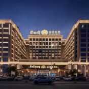 Night view of Jin Bei Palace Hotel showcasing its grand illuminated facade and iconic high-rise design in Sihanoukville