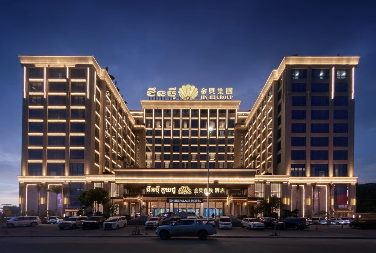 Night view of Jin Bei Palace Hotel showcasing its grand illuminated facade and iconic high-rise design in Sihanoukville