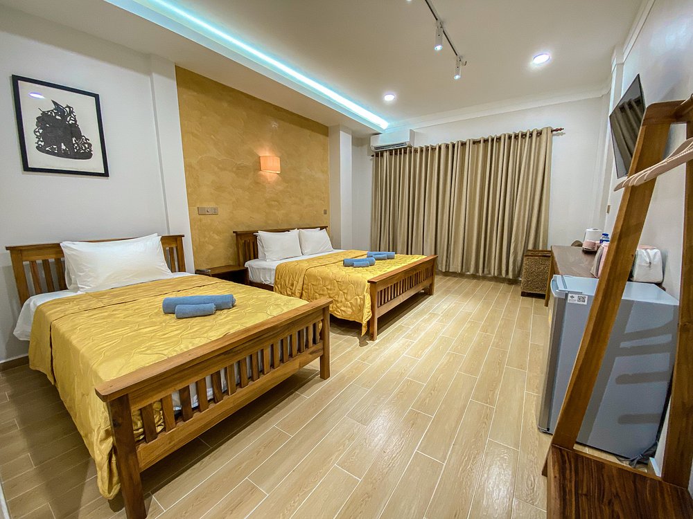 A family room with two large beds at Muni Residence & Spa.