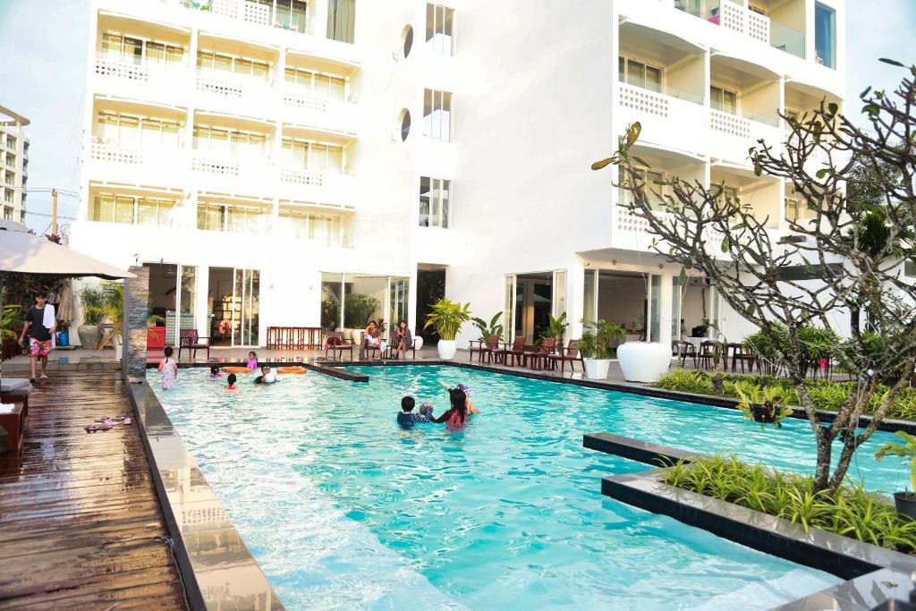 Main swimming pool at Naia Resort Sihanoukville reflecting the tranquil evening atmosphere of the beachfront resort