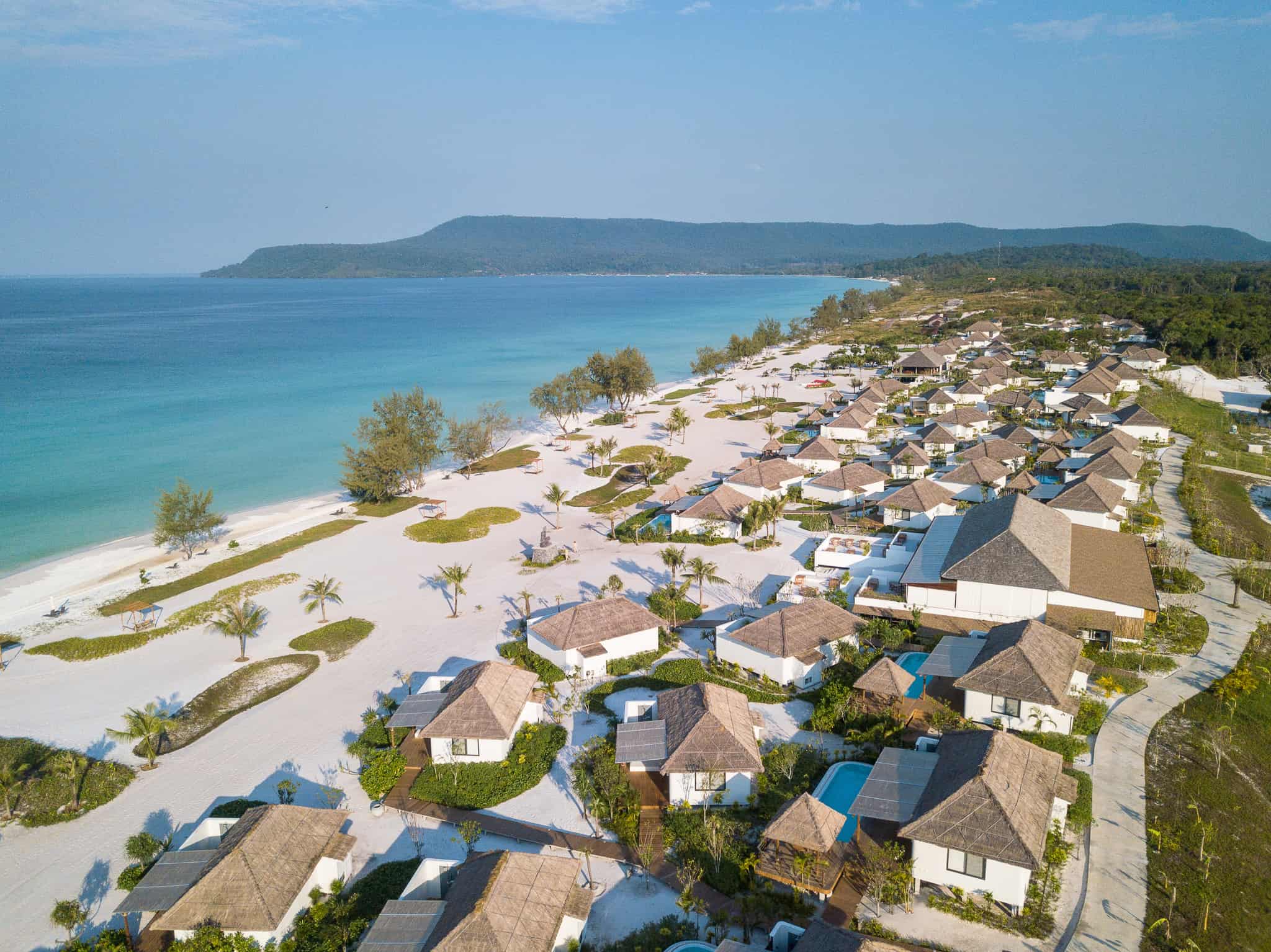 Aerial view of The Royal Sands Koh Rong showcasing beachfront villas, white sandy beach, and turquoise sea on Koh Rong Island