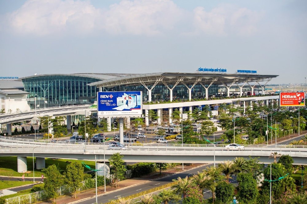 Noi Bai International Airport Vietnam terminal exterior with modern architecture and surrounding transport infrastructure