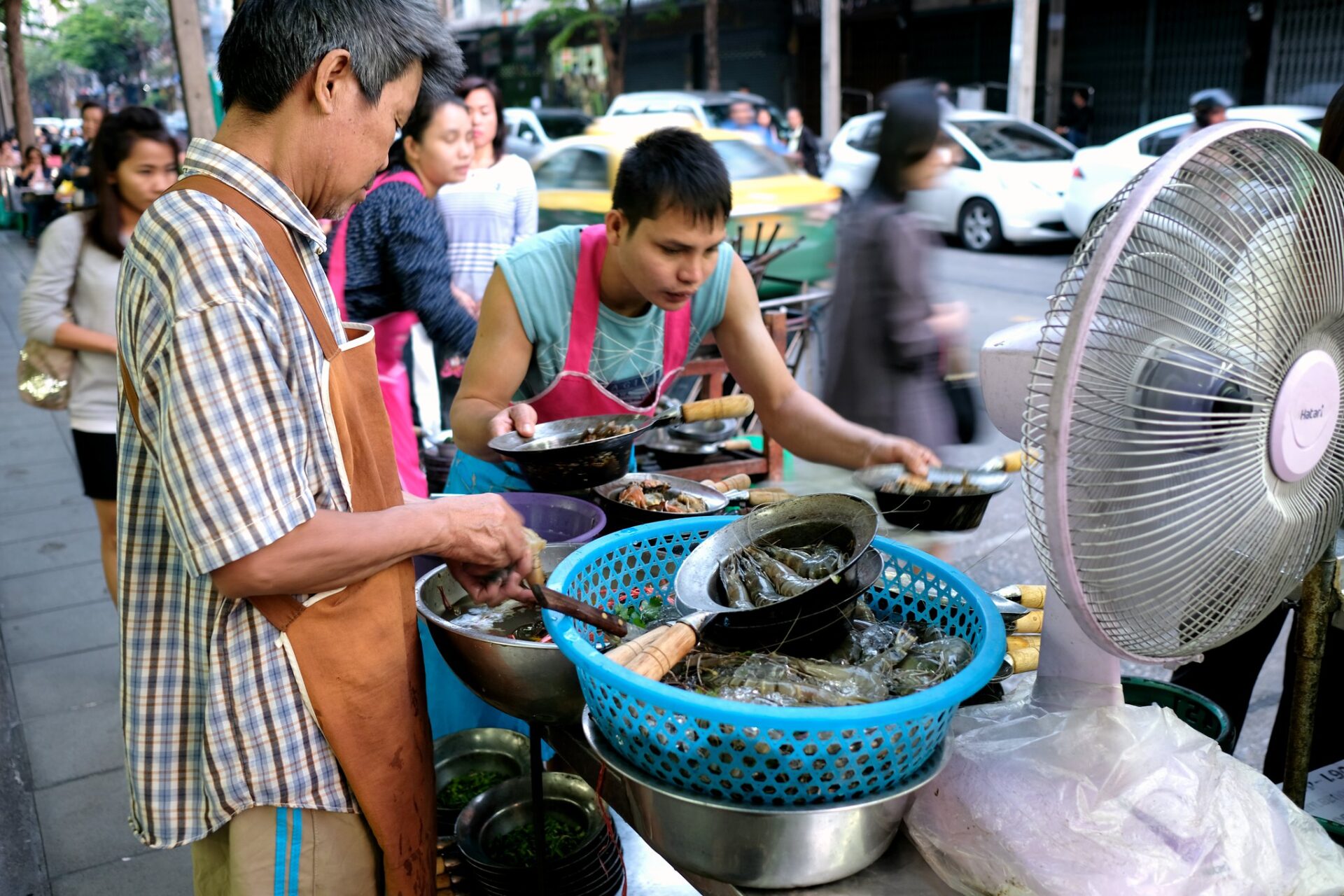Street cooks preparing seafood at Bangkok Street Food MICHELIN Restaurants, Somsak Pu Ob Bangkok stall