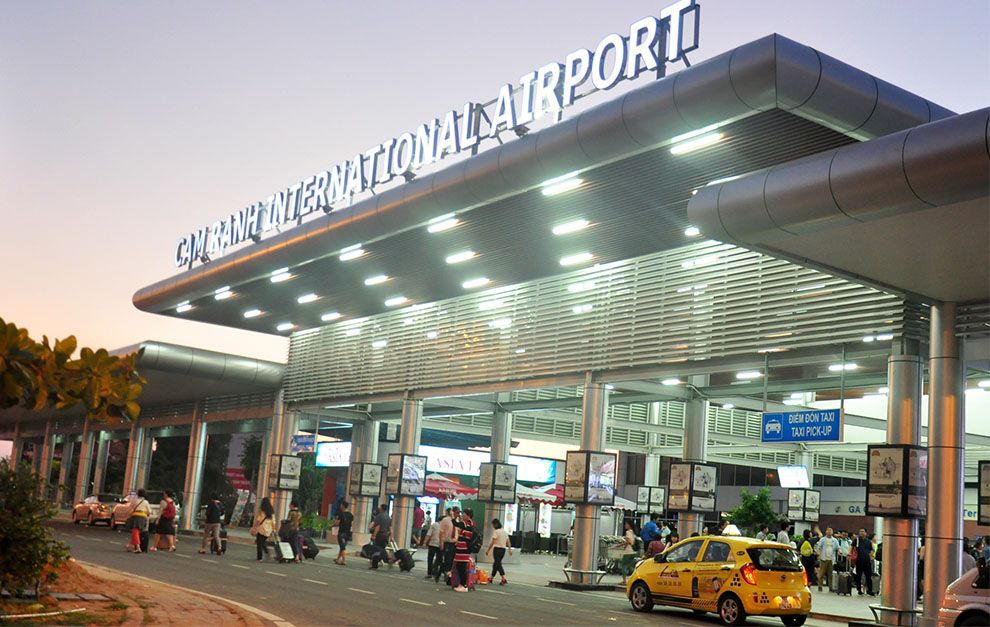 Cam Ranh International Airport Vietnam entrance at night with bright lighting and active passenger pick-up area