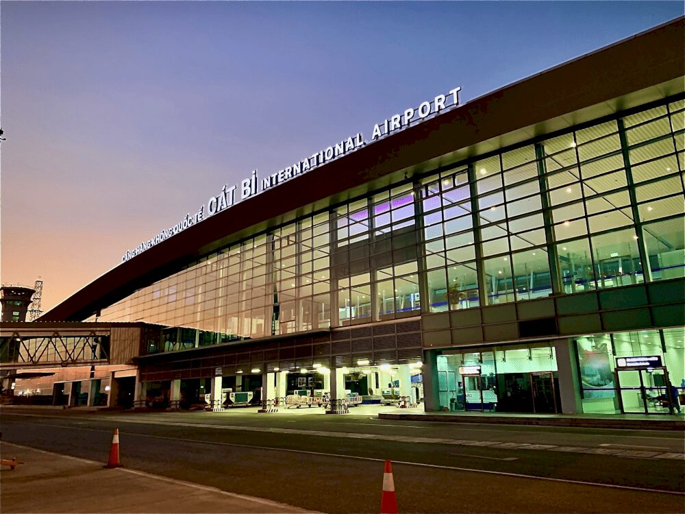 Cat Bi International Airport Vietnam terminal in Hai Phong with modern glass architecture at sunset