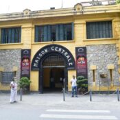 The Many Names of Hanoi Hilton Prison: The entrance to Hoa Lo Prison, showing the historic French colonial name 'MAISON CENTRALE' on the facade.