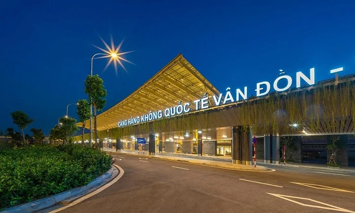 Van Don International Airport Vietnam exterior with unique wooden roof design and quiet roadway at night