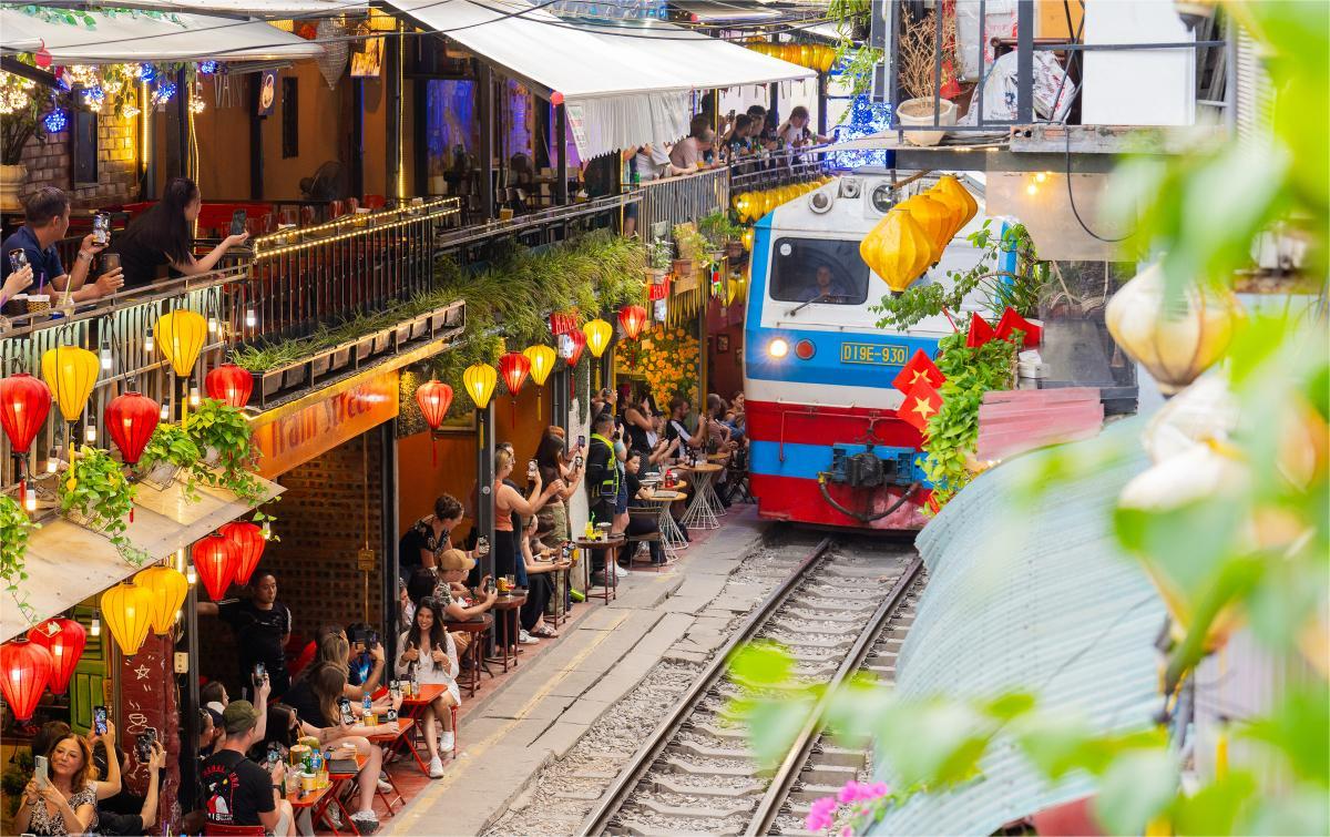 Evening cafés and train passing Hanoi train street