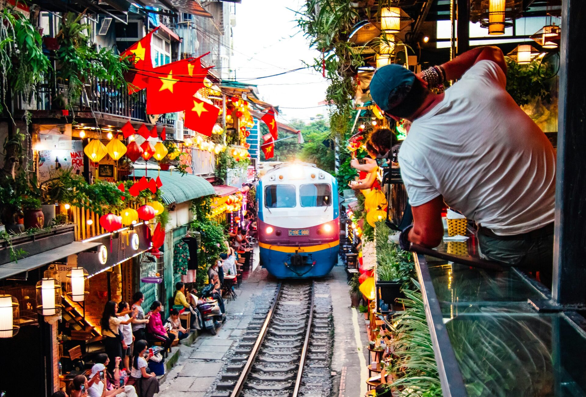 A train passing through the famous Hanoi Train Street, one of the most popular things to do in Vietnam