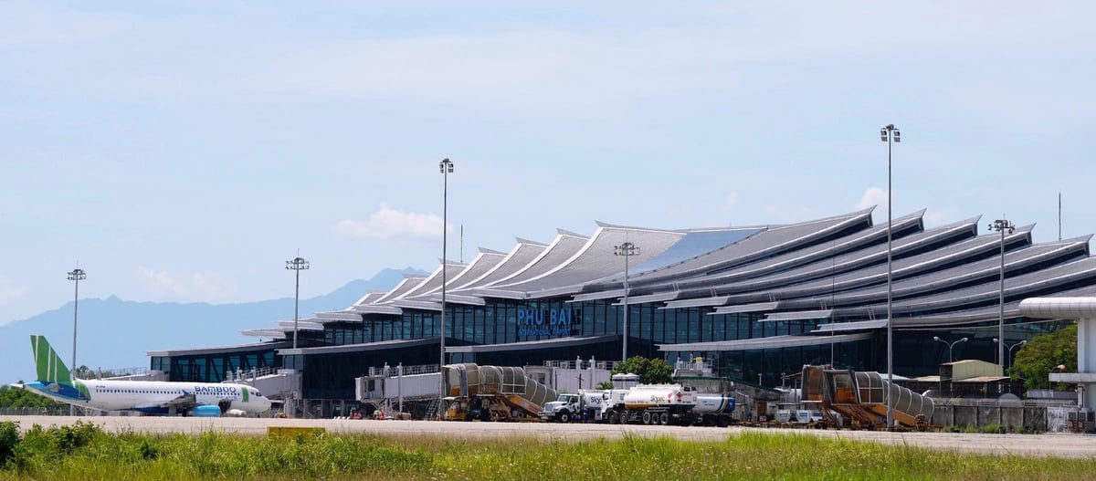 Phu Bai Airport in Hue Vietnam showing terminal building and airplanes at the airport apron