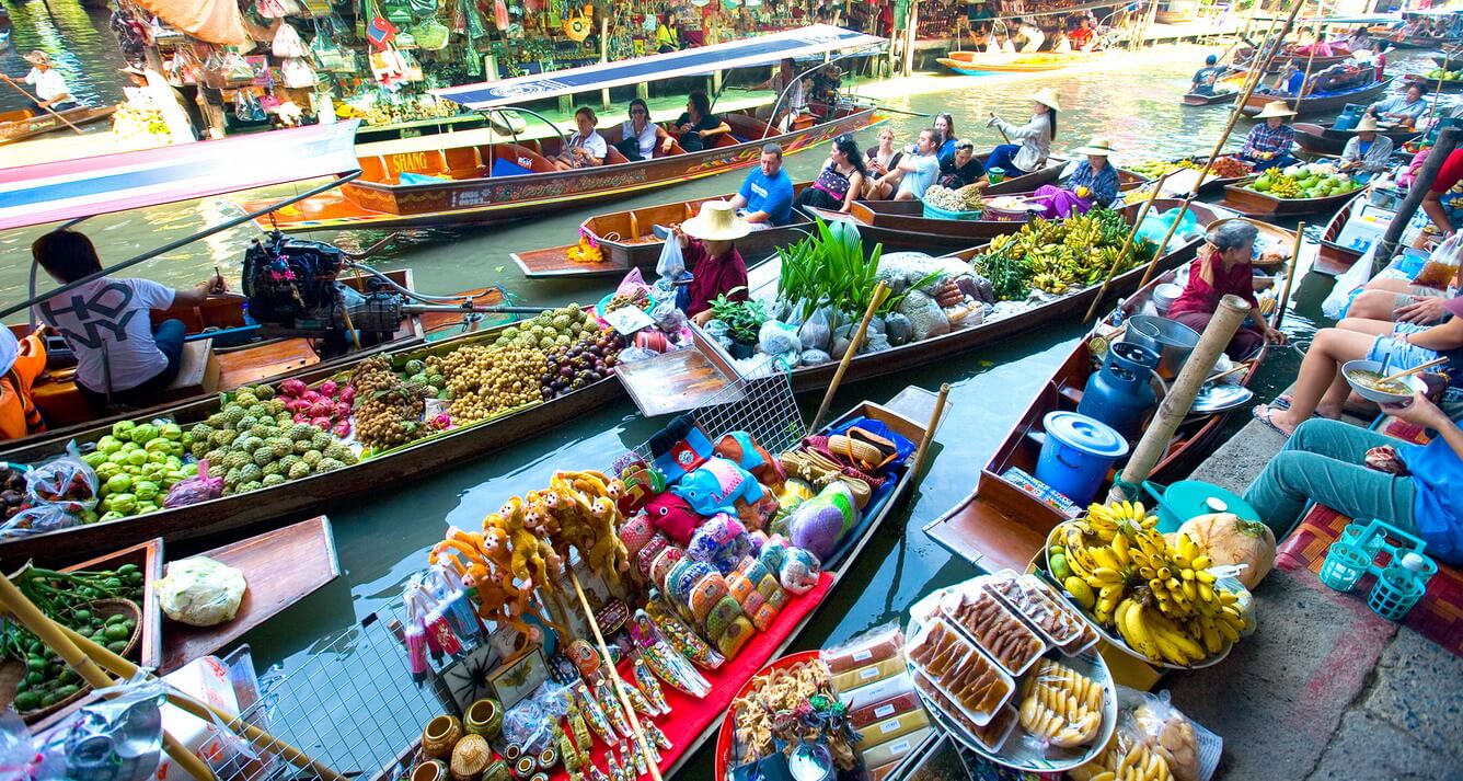 Vibrant scene at Cai Be Floating Market with boats full of tropical fruits, a classic choice for things to do Vietnam