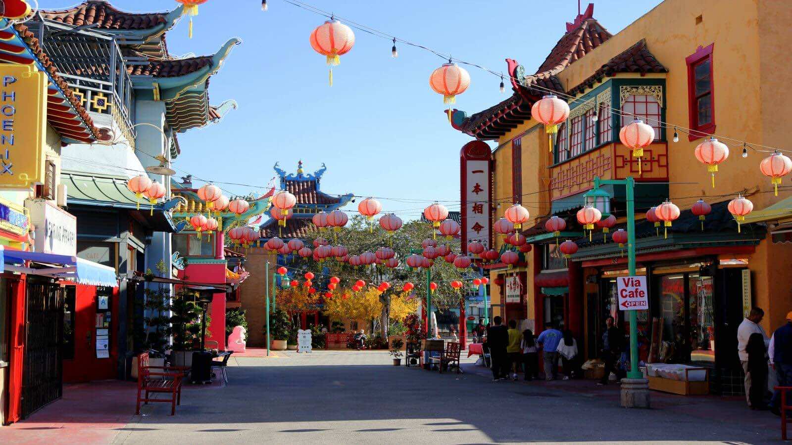 A vibrant street view of traditional architecture and hanging red lanterns in Cholon (Chinatown), a cultural landmark often visited on a Ho Chi Minh City tour