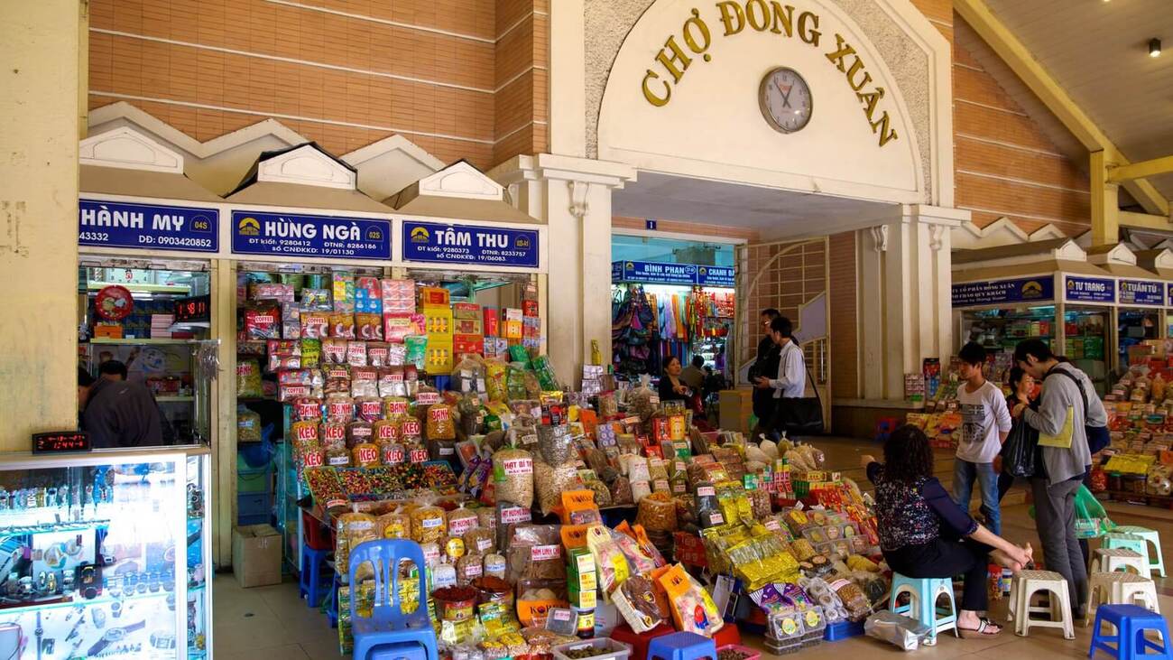 Dong Xuan Market stalls selling local snacks, classic what to buy in hanoi