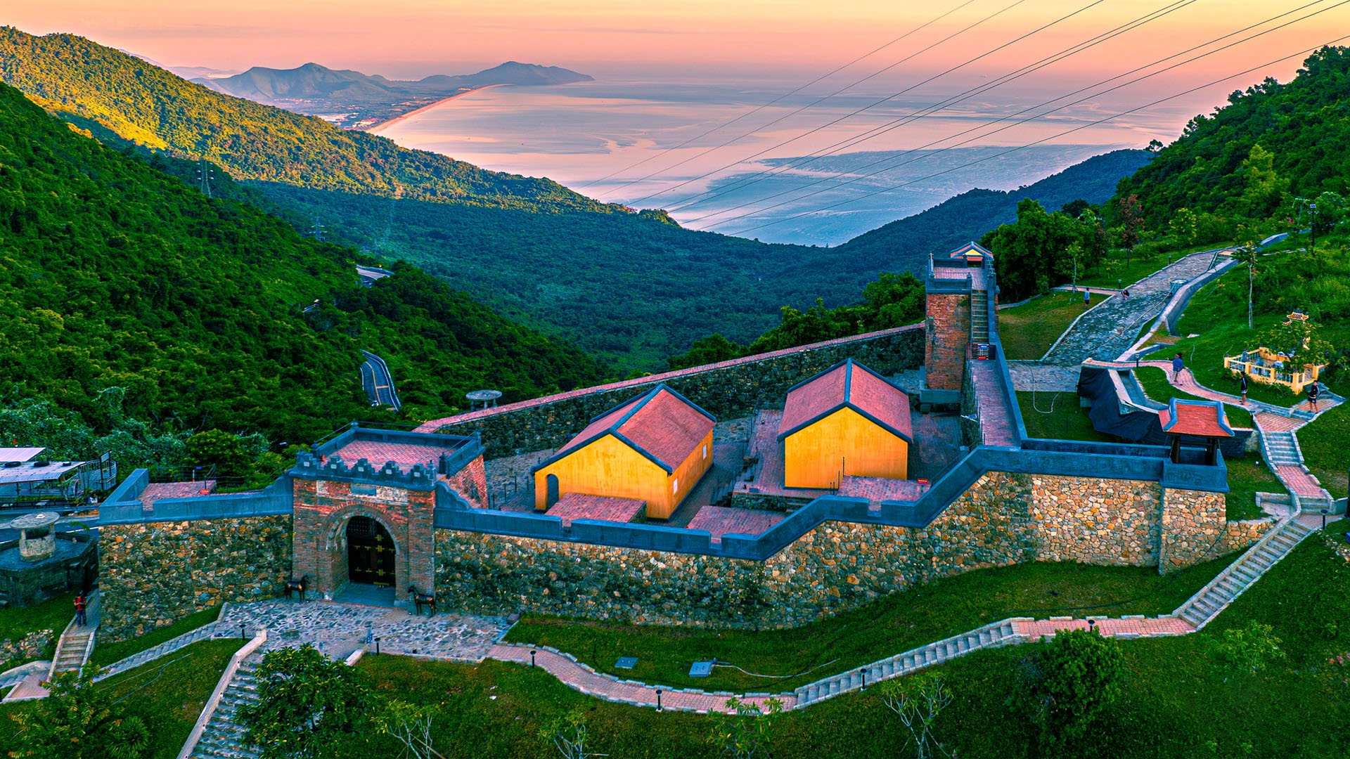 The historic gate at the summit of Hai Van Pass overlooking the coast, representing one of the most scenic road trip things to do in Vietnam