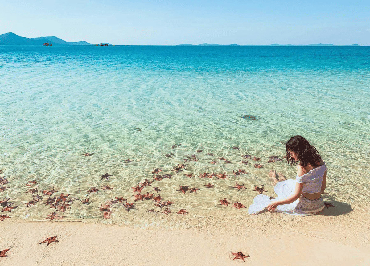 Crystal clear waters and red starfish at Sao Beach in Phu Quoc, a top-rated choice for things to do Vietnam