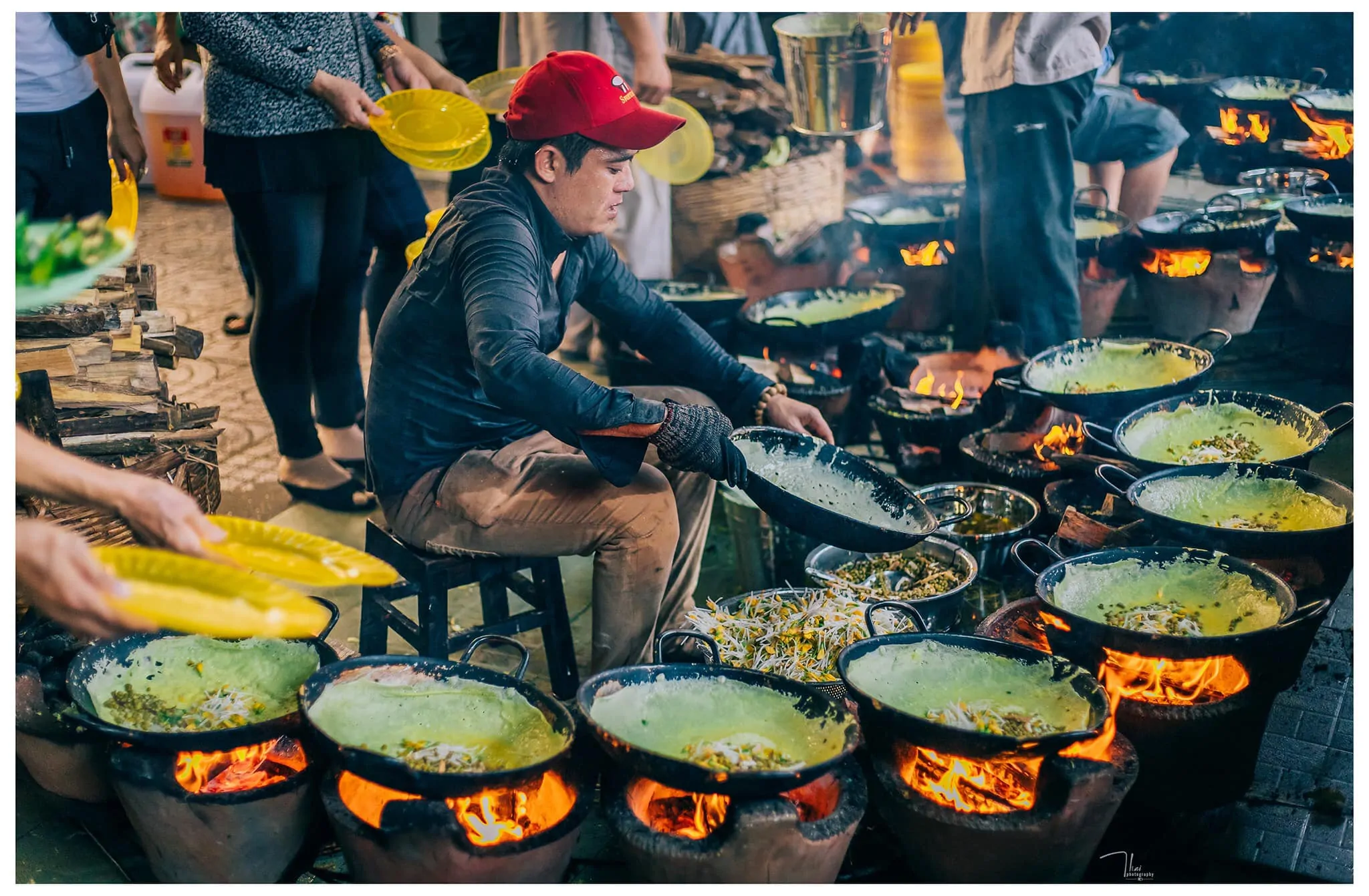 A street food vendor expertly preparing crispy Banh Xeo, a highlight of the ultimate street food crawl on a Ho Chi Minh City tour