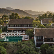 Panoramic view of Belmond La Résidence Phou Vao surrounded by lush tropical gardens and tranquil hillside landscape in Luang Prabang